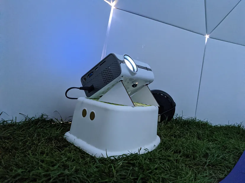 Projector propped up by cardboard