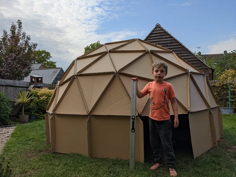 My son stands in front of the dome with a metre stick for scale